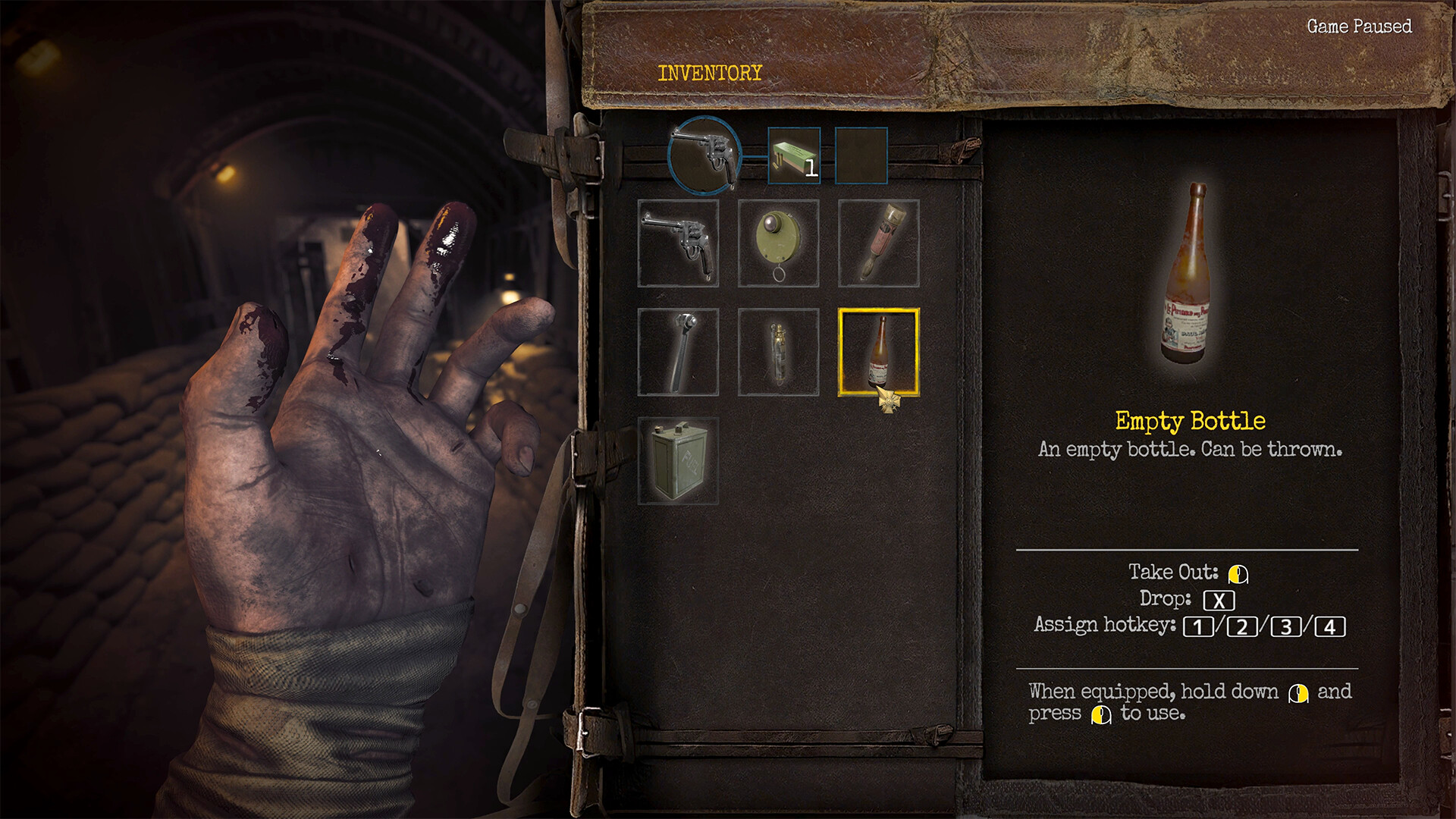Henri’s inventory with a revolver, ammunition, a grenade, a torch and an empty bottle; a lightly bloodied hand